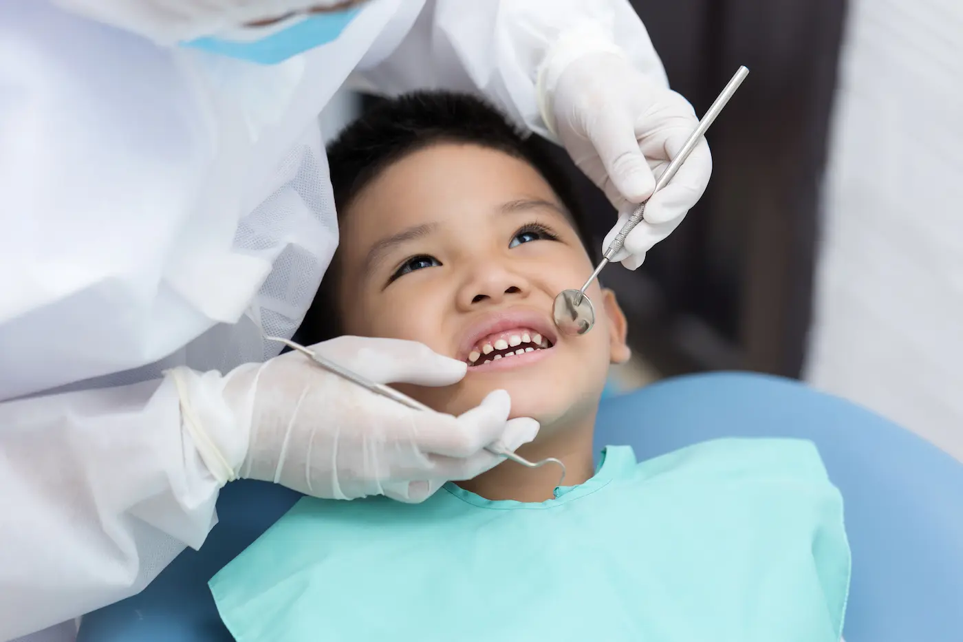 A young boy smiling during a gentle dental checkup