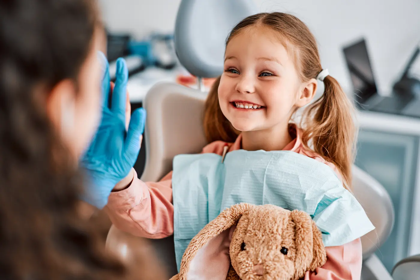A young patient smiling in the dental chair
