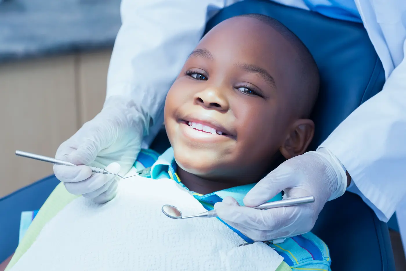 A smiling child in the dental chair during treatment