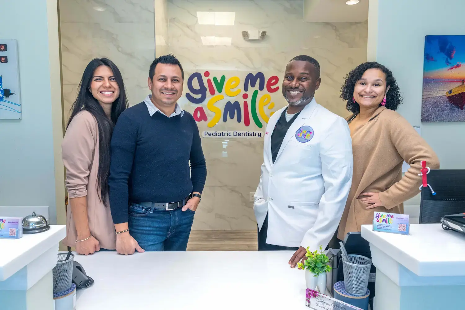 The Give Me A Smile team welcoming families at the front desk